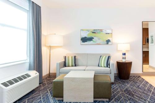 a living room with a couch and a table at Homewood Suites By Hilton Broomfield Boulder in Broomfield