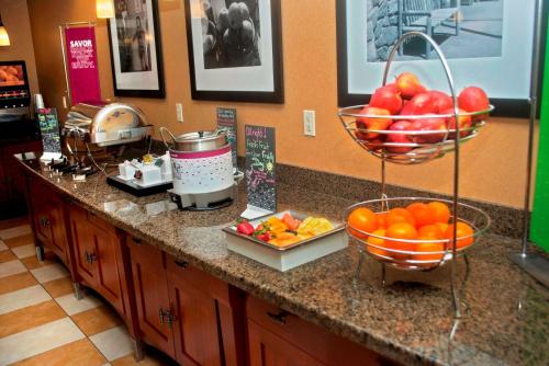 a kitchen counter with bowls of fruit on it at Hampton Inn Evanston in Evanston