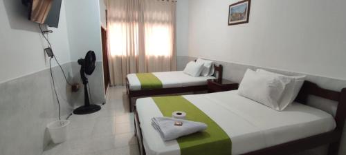a hotel room with two beds and a phone at Luna verde hotel in Neiva
