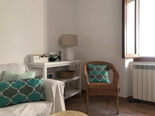 a living room with a couch and a chair at CasaMare. Orbetello centro storico. in Orbetello