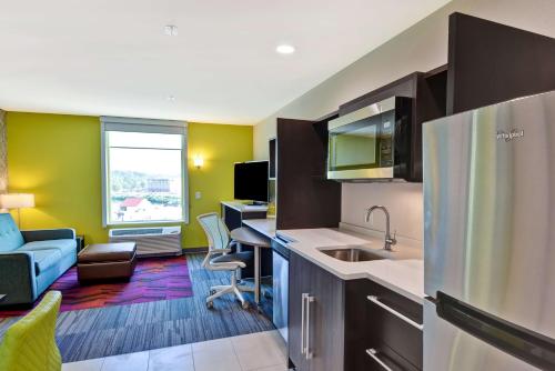 a kitchen with a couch and a desk in a room at Home2 Suites By Hilton Hot Springs in Hot Springs