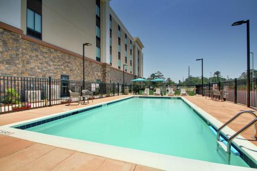 a swimming pool in the middle of a building at Hampton Inn & Suites By Hilton Southport in Southport