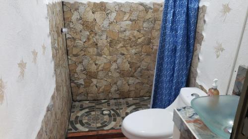 a bathroom with a shower and a toilet and a sink at Lo de Reyes Monterrico y Sipacate in Las Quechas