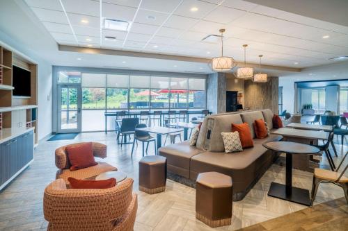 a living room with a couch and chairs and tables at Home2 Suites By Hilton North Little Rock, Ar in North Little Rock