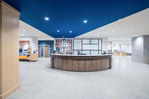 an office lobby with a reception counter and blue ceilings at Home2 Suites By Hilton North Little Rock, Ar in North Little Rock