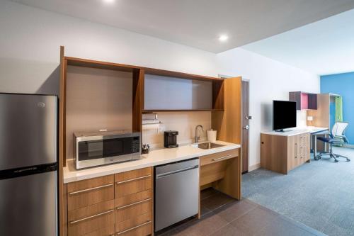 a kitchen with a microwave and a refrigerator at Home2 Suites By Hilton North Little Rock, Ar in North Little Rock