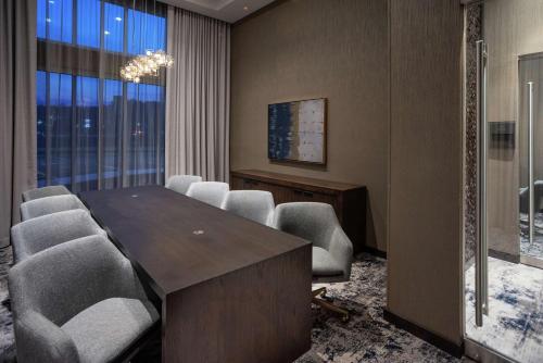 a conference room with a table and chairs and a window at Hilton Garden Inn Hanover Lebanon in Lebanon