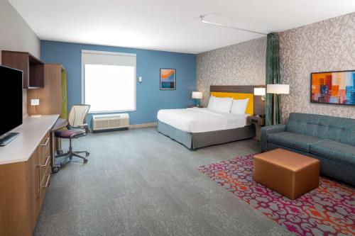 a hotel room with a bed and a couch at Home2 Suites By Hilton North Little Rock, Ar in North Little Rock