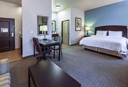 a large hotel room with a bed and a desk at Hampton Inn and Suites Lake Jackson-Clute in Clute