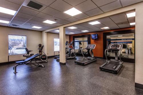 a gym with several treadmills and elliptical machines at Hampton Inn Junction City in Junction City