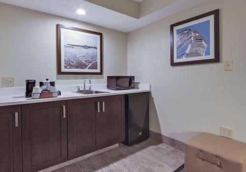 a kitchen with a sink and a microwave at Hampton Inn Myrtle Beach Broadway at the Beach in Myrtle Beach