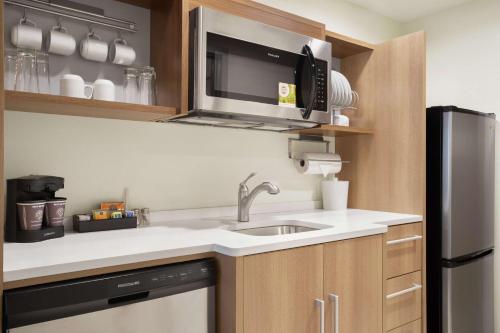 a kitchen with a sink and a microwave at Home2 Suites By Hilton Warminster Horsham in Warminster