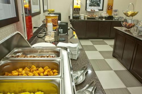 a kitchen with a counter with food on it at Hampton Inn & Suites Denison in Denison