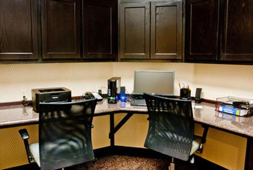 an office with a desk with a laptop and two chairs at Hampton Inn & Suites Denison in Denison