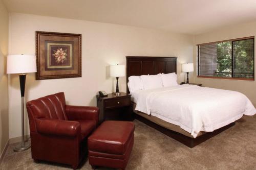 a hotel room with a bed and a chair at Hampton Inn Richland-Tri Cities in Richland