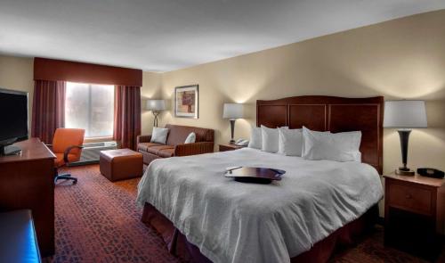 a hotel room with a bed with a tray on it at Hampton Inn Provo in Provo