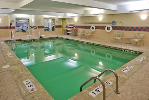 a large swimming pool with green water at Hampton Inn & Suites Rifle in Rifle