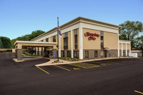 an empty parking lot in front of a shopping center at Hampton Inn Rochester in Rochester