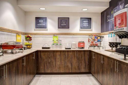 a restaurant kitchen with wooden cabinets and a counter at Hampton Inn Rochester in Rochester