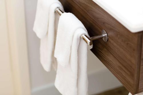 a close up of towels hanging on a bathroom door at Hampton Inn Rochester in Rochester