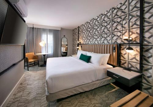 a hotel room with a large bed and a desk at Hotel Virginia Santa Barbara, Tapestry Collection by Hilton in Santa Barbara