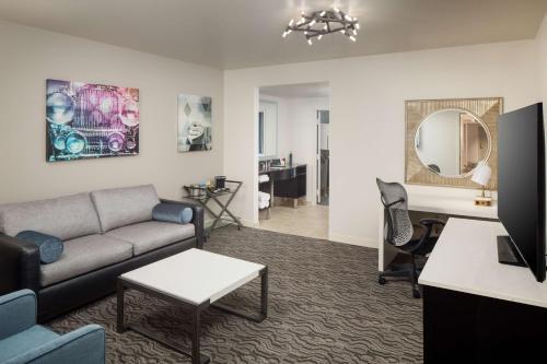 a living room with a couch and a table at DoubleTree Suites by Hilton Hotel Detroit Downtown - Fort Shelby in Detroit