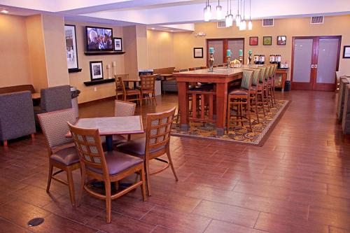 a restaurant with tables and chairs and a dining room at Hampton Inn Sidney in Sidney