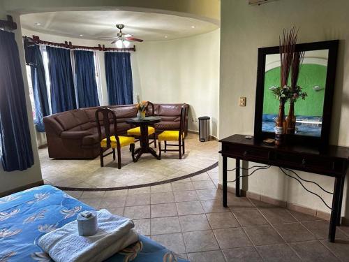 a living room with a couch and a table at Hotel Castillo Del Mar - 5 Th Ave in Playa del Carmen