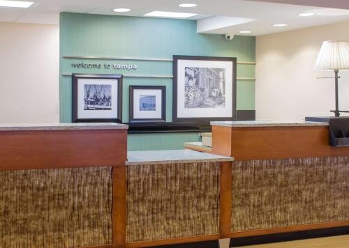 a waiting room with pictures on the wall at Hampton Inn Tampa-Veterans Expressway in Tampa
