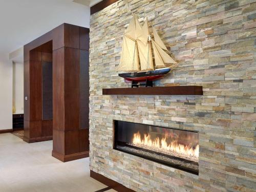 a fireplace with a model of a boat on it at Homewood Suites by Hilton Halifax - Downtown in Halifax