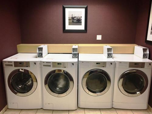three washers and dryers in a laundry room at Hampton Inn & Suites Chesapeake-Battlefield Boulevard in Chesapeake