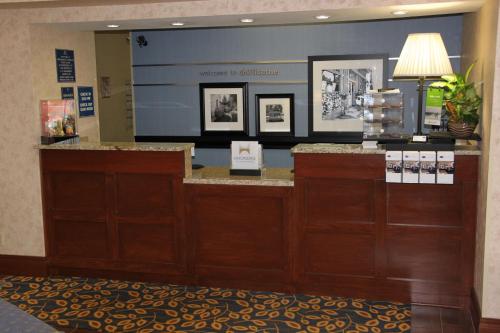 a lobby of a hotel with a reception counter with photographs at Hampton Inn & Suites Chillicothe in Chillicothe