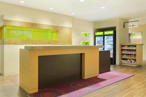 a lobby with a fireplace in a store at Home2 Suites by Hilton Canton in North Canton