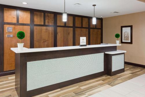 a lobby of a hotel with a reception counter at Homewood Suites Davenport in Bettendorf