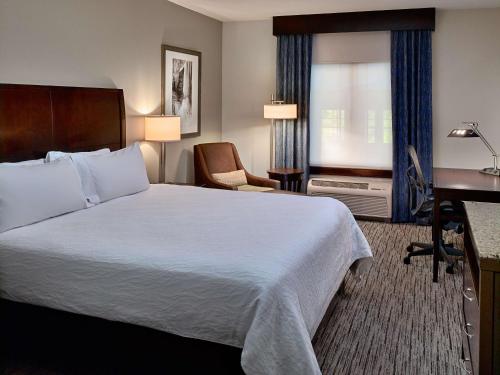 a hotel room with a bed and a desk at Hilton Garden Inn Gatlinburg in Gatlinburg