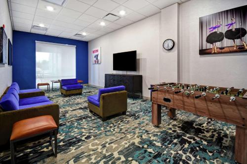 a waiting room with a game table and a tv at Home2 Suites By Hilton San Francisco Airport North in South San Francisco