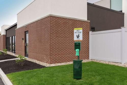 a parking meter in front of a brick building at Home2 Suites By Hilton Indianapolis Airport in Indianapolis