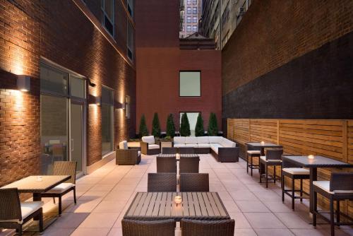 a restaurant with tables and chairs in a building at Hilton Garden Inn New York Times Square South in New York