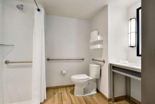 a bathroom with a toilet and a sink at Hilton Garden Inn New York Times Square South in New York