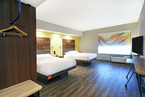 a hotel room with two beds and a flat screen tv at Tru By Hilton Portland Airport Area Me in South Portland