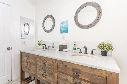 a bathroom with two sinks and two mirrors at Walk 2 Beach Parking A C W D 15min 2LAX Remodel in Manhattan Beach