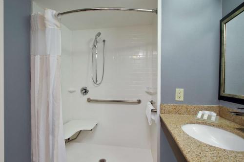 a bathroom with a shower and a sink at Hilton Garden Inn Austin NorthWest/Arboretum in Austin