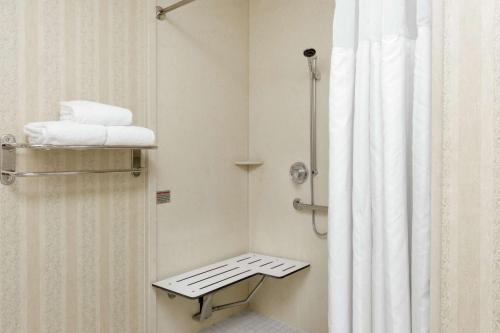 a bathroom with a shower with a shower curtain at Hilton Garden Inn Sacramento Elk Grove in Elk Grove