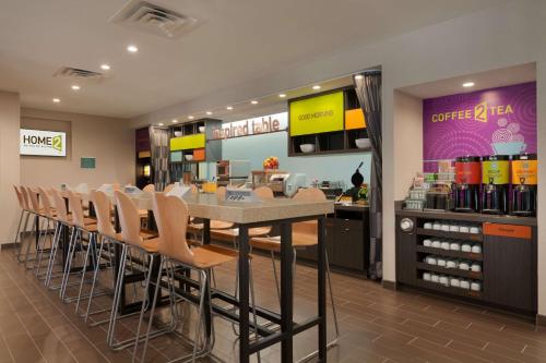 a restaurant with a table and chairs in a store at Home2 Suites by Hilton Oklahoma City South in Oklahoma City