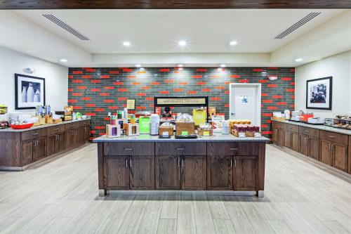 a large room with a counter with food on it at Hampton Inn North Little Rock McCain Mall, AR in North Little Rock