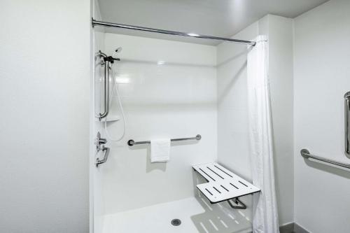 a small bathroom with a shower and a toilet at Hampton Inn North Little Rock McCain Mall, AR in North Little Rock