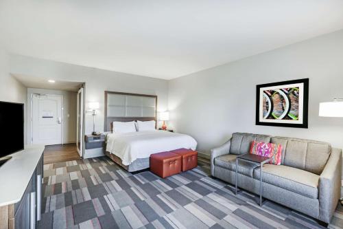a hotel room with a bed and a couch at Hampton Inn North Little Rock McCain Mall, AR in North Little Rock