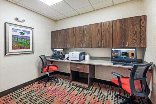 an office with a desk with a computer and two chairs at Hampton Inn North Little Rock McCain Mall, AR in North Little Rock