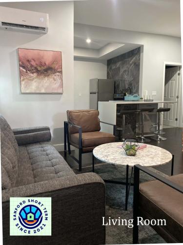 a living room with a couch and a table at The Front Porch in Sanford