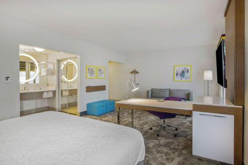 a hotel room with a bed and a desk with a computer at Hampton Inn & Suites Raleigh-Durham Airport-Brier Creek in Raleigh